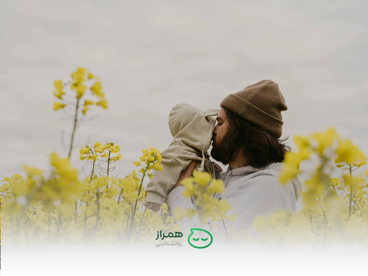 Father kissing baby in flower field – symbol of love and secure attachment – Hamraz Psychology