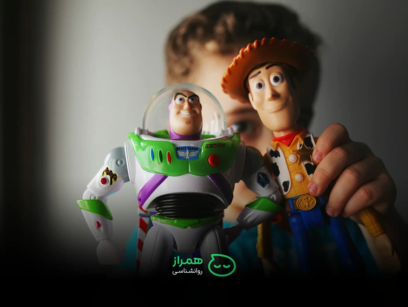 Child holding Toy Story characters Buzz Lightyear and Woody – imagination and emotional expression – Hamraz Psychology