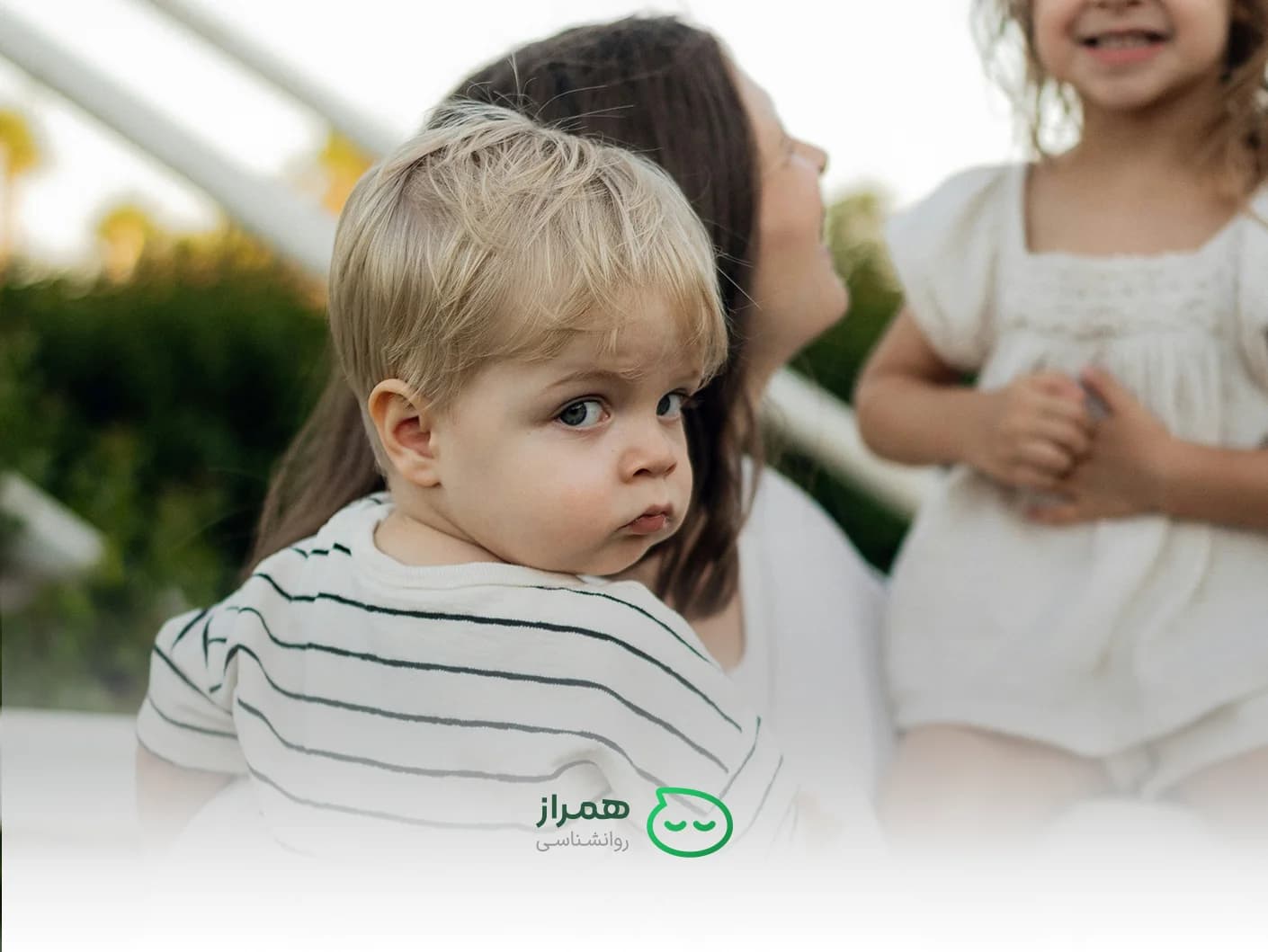 Curious baby looking back while being held by mother – emotional bonding and child development – Hamraz Psychology