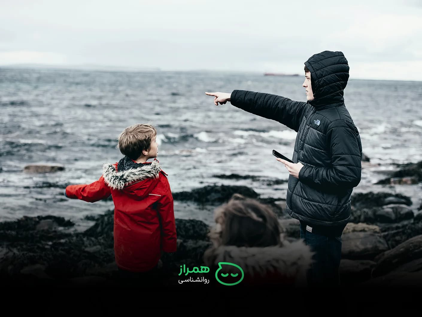 Teen guiding younger child by the sea – mentorship, protection and sibling bond – Hamraz Psychology